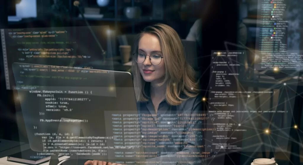 Mulher programadora com código projetado, simbolizando as Tendências Gartner 2025. Destaque para Inteligência Artificial e eficiência energética como foco da tecnologia futura. Ideal para temas de inovação e transformação digital.